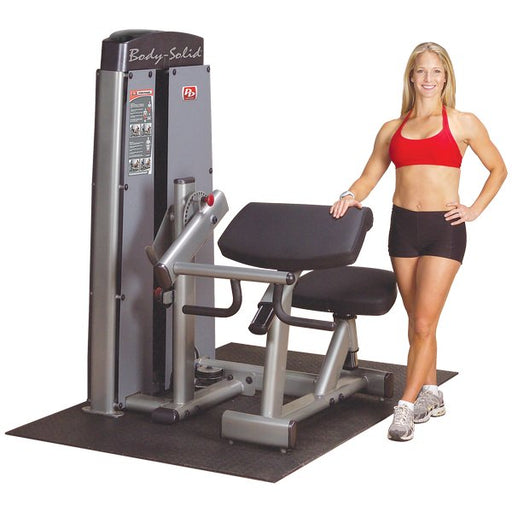 Athlete standing next to the Body-Solid Pro Dual Bicep/Tricep Machine DBTC-SF
