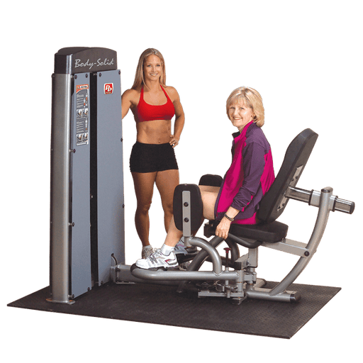 Personal trainer assisting an older woman using the Body-Solid Pro Dual Inner/Outer Thigh Machine DIOT-SF