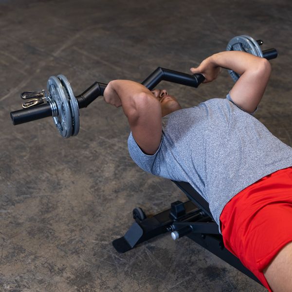 Male athlete performing a tricep skull crusher with the Body-Solid FAT CURL BAR OB48F, demonstrating the bar's thick 2" grip and effectiveness in targeting the triceps during strength training.