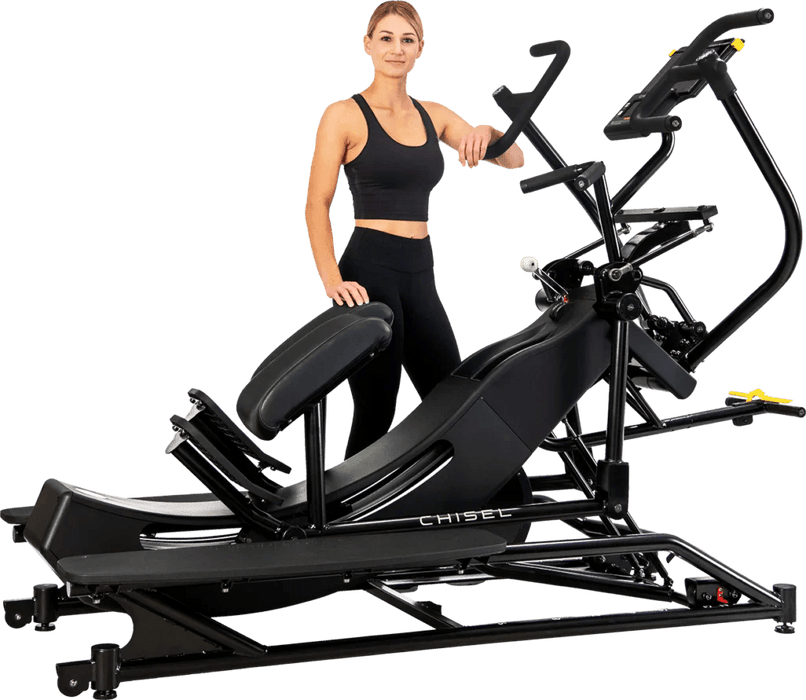 Female athlete standing next to the Chisel Challenger, preparing for a workout, showcasing the machine's sleek design and ready-to-use setup in a fitness environment.

