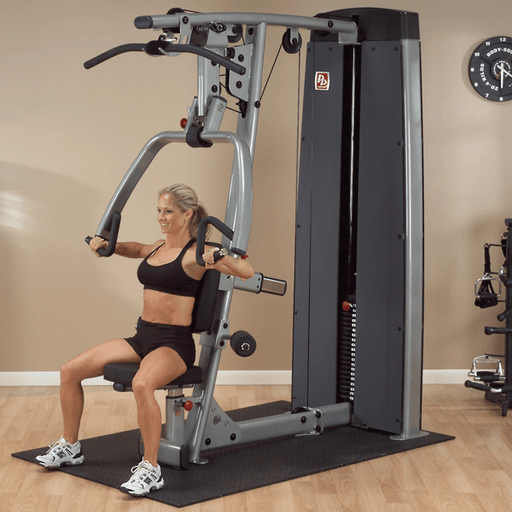 Athlete performing an exercise on the Body-Solid Pro Dual Vertical Press & Lat Machine DPLS-SF