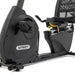 Bottom half view from front to back of the Spirit Fitness XBR95 Recumbent Bike, highlighting the large cushioned quick-latch foot pedals, sturdy frame, and transport wheels.