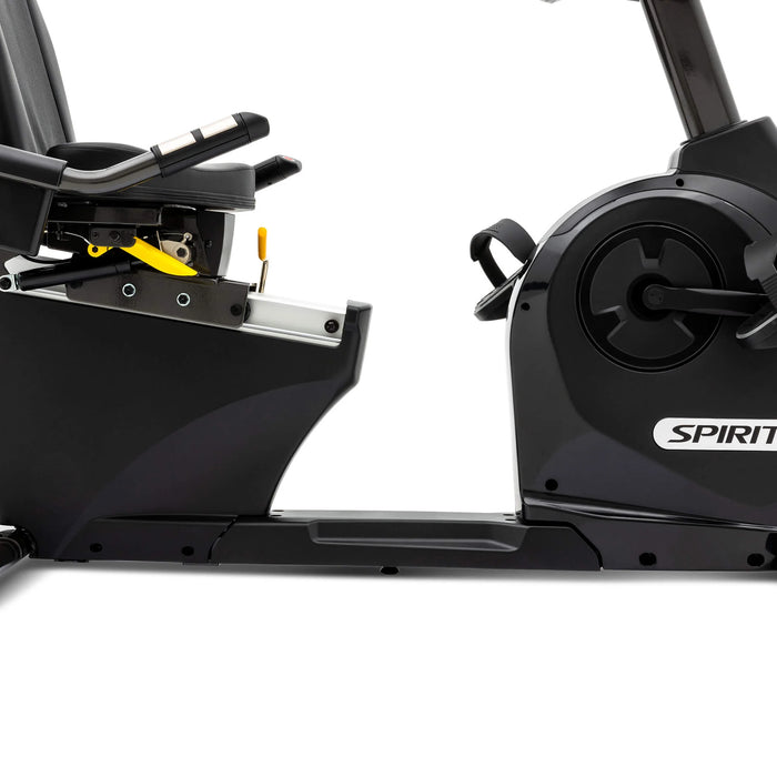 Close-up view of the right side bottom half of the Spirit Fitness XBR95 Recumbent Bike, showcasing the quick-latch foot pedals, sturdy frame, and transport wheels.