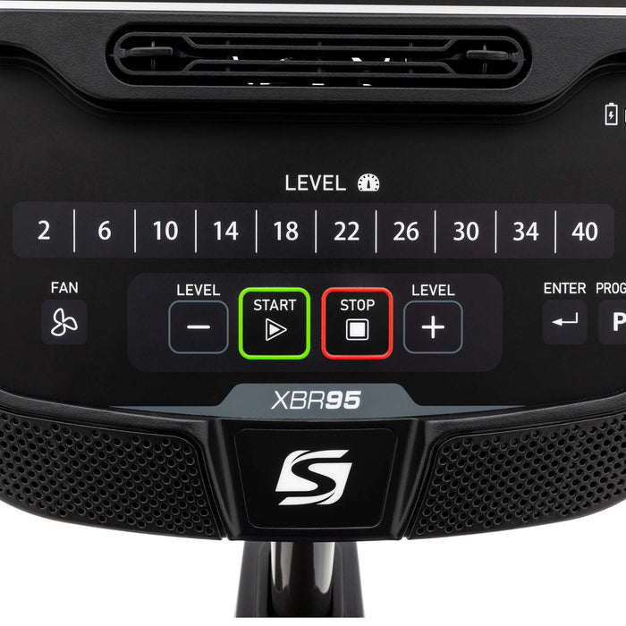 Close-up front-on view of the bottom area of the Spirit Fitness XBR95 Recumbent Bike console, highlighting the direct resistance buttons, built-in Bluetooth speakers, and control panel.