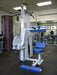 Legend Fitness Ab Crunch Machine 941 with white frame and blue upholstery in a gym setting, featuring adjustable seat, ankle rollers, and full-range crunch motion.