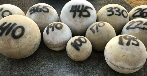 ISF Atlas Stones in various sizes from 100lbs to 445 lbs on a road, made in the USA.