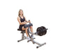 Female athlete working out on the Body-Solid GSCR349B Seated Calf Raise Machine, demonstrating proper use and form.